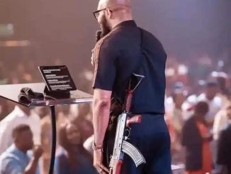 SHOCKING: Pastor Mounts Pulpit To Preach With AK-47 Rifle In Abuja (Video)